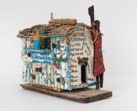 Beverly Buchanan, Orangeburg County Family House, 1993. Paint, sharpie, garland, necklace, wood chips, bark, buttons, bottle caps, license plate, film canister, thumbtacks, clay pot, glass bottle, thread and glue on wood. Image courtesy Andrew Edlin gallery, New York.