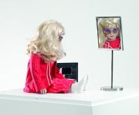 Lynn Hershman Leeson, <em>CyberRoberta</em>, 1996. Custom-made doll, clothing, glasses, webcam, surveillance camera, mirror, original programming, and telerobotic head-rotating system, Aprox. 17 ¾ x 17 ¾  x 7 ⅞  in (45 x 45 x 20 cm). Courtesy the artist; Bridget Donahue Gallery, New York; and Altman Siegel, San Francisco