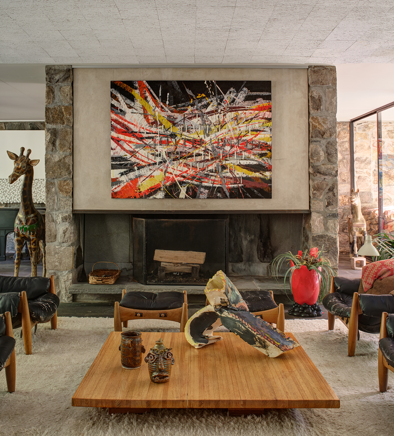 At The Noyes House: Blum & Poe, Mendes Wood DM and Object & Thing. The Noyes House, New Canaan, Connecticut. Photo by Michael Biondo. Works pictured [left to right]: Mark Grotjahn, Untitled (Capri 53.16) (2020); Gaetano Pesce, Large Red Pebble Vase (2016); Coffee table: Jim McDowell, Madison Washington (2017) and Love Trumps Hate (2019); Lynda Benglis, AMAXA (2013).