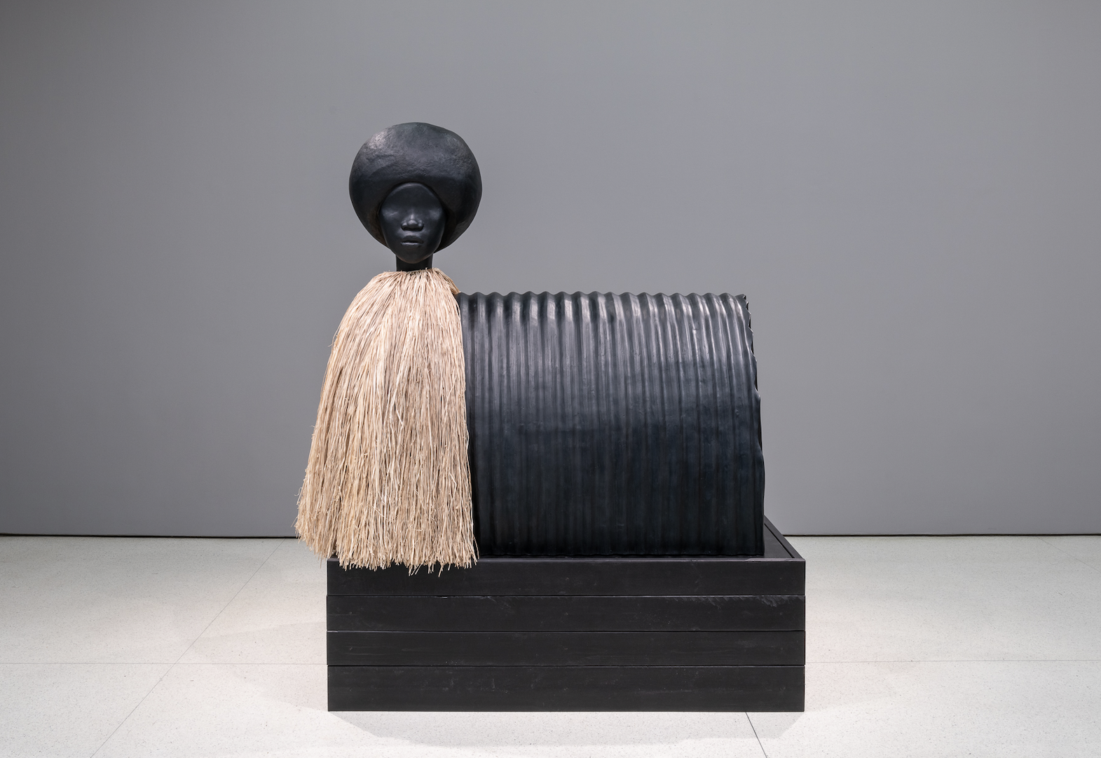 Simone Leigh, _Sentinel_, 2019. Bronze and raffia, 81 x 73 x 40 1/2 inches. Installation view: The Hugo Boss Prize 2018: Simone Leigh, Loophole of Retreat, Solomon R. Guggenheim Museum, New York, April 19–October 27, 2019. Photo: David Heald © 2019 The Solomon R. Guggenheim Foundation