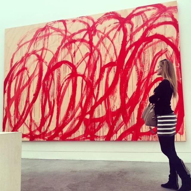 Sarah Arison with a painting by Cy Twombly, at Tate Modern in 2015.