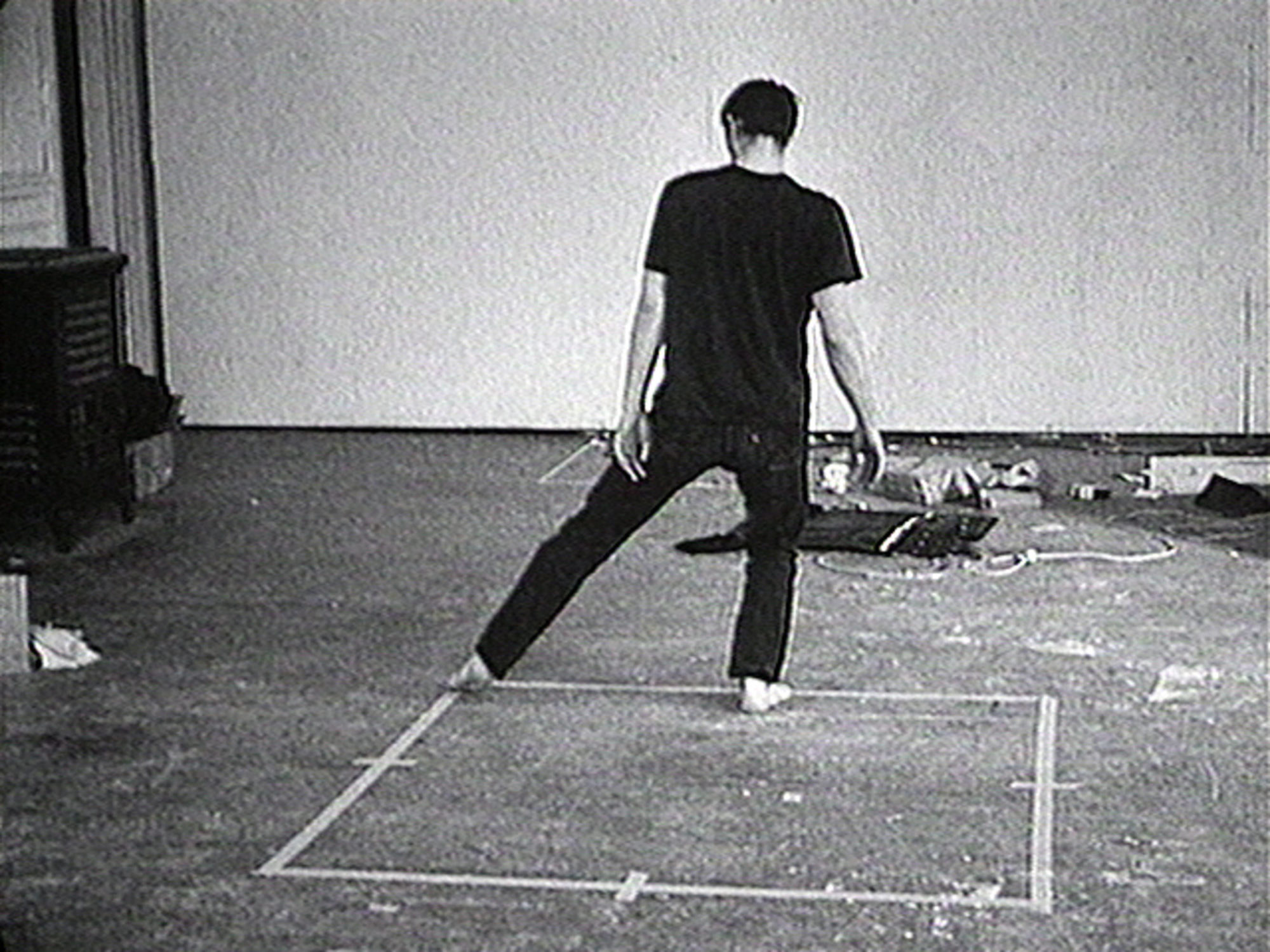 Bruce Nauman (American, born 1941). Dance or Exercise on the Perimeter of a Square (Square Dance). 1967‑1968. 16mm film transferred to video (black and white, sound). 10 min.. Uneditioned. The Museum of Modern Art, New York. Acquired through the generosity of Evanne and Edward J. Gargiulo, Jr. in honor of Ava, Emma and Jack Gargiulo. © 2021 Bruce Nauman / Artists Rights Society (ARS). Courtesy Electronic Arts Intermix (EAI), New York. 581.2008.